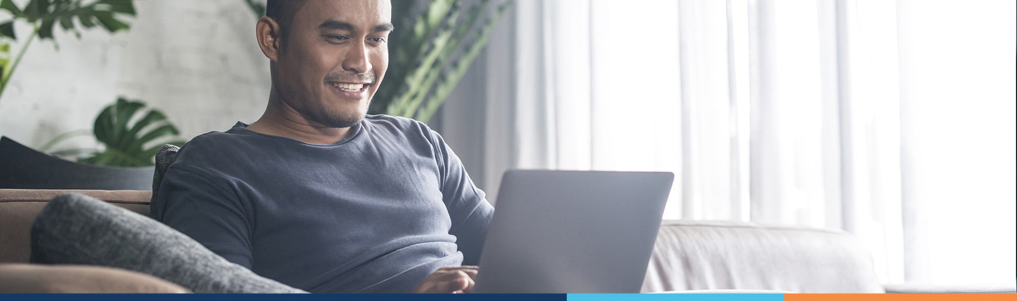 man smiling looking at dental plans online