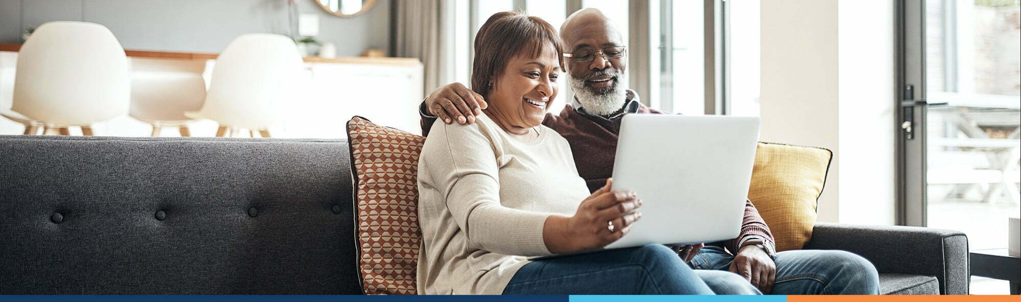 couple reviewing dental plan options on laptop