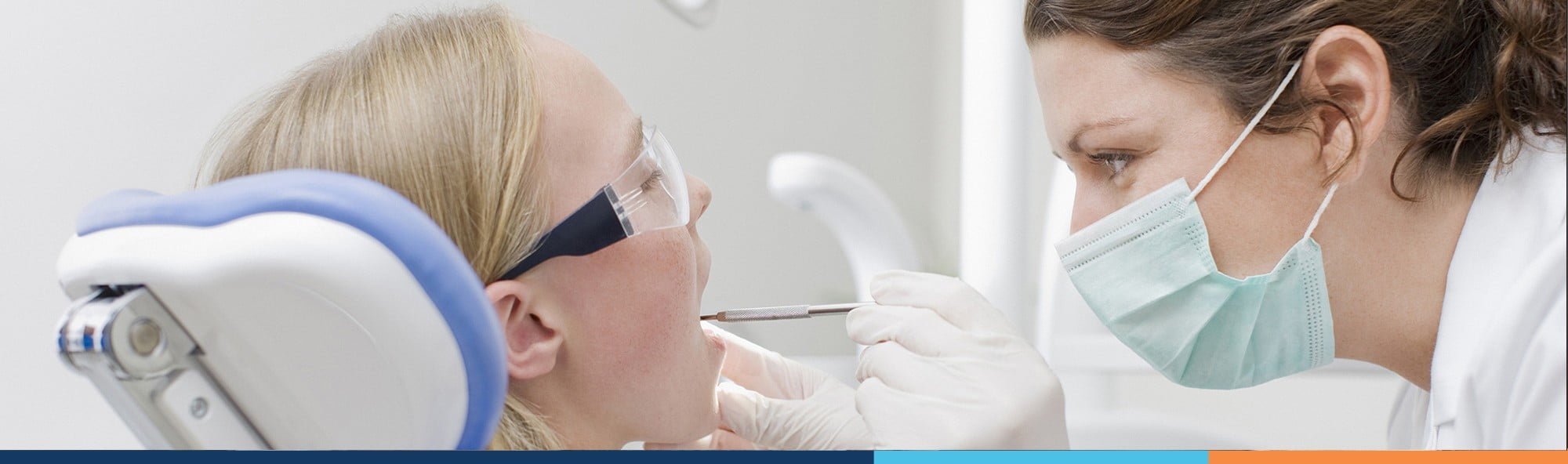 dentist inspecting patient mouth